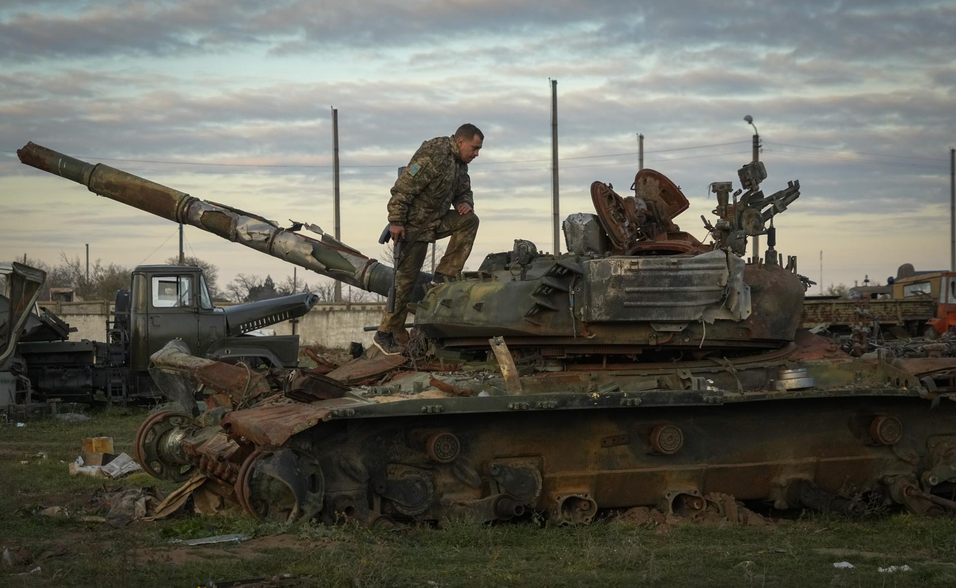 Ukrajinský vojak kontroluje poškodený ruský tank v dedine Čornobajvka pri Chersone